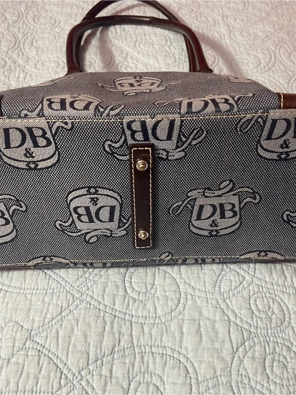Dooney and Bourke Monogram Denim Donegal Dome Satchel with brown leather trim.